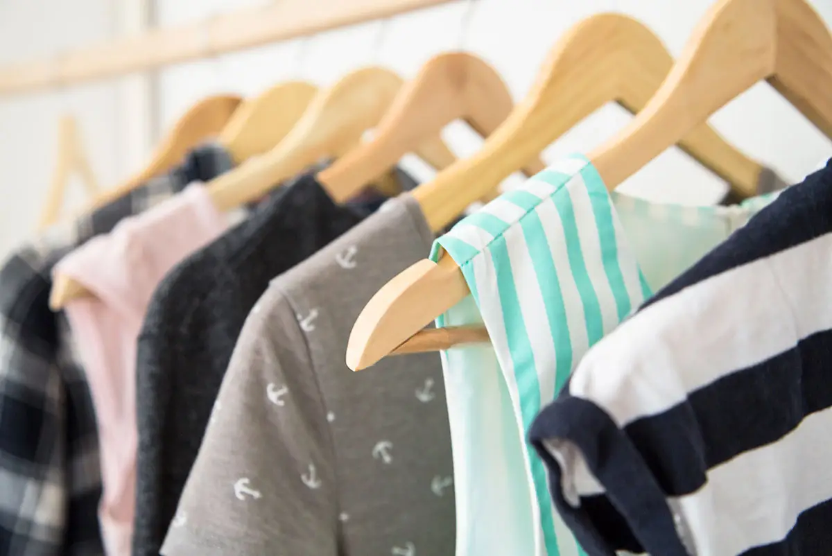 a closet full of clothes hanging on racks to show how filling their closet gives the tools educators need