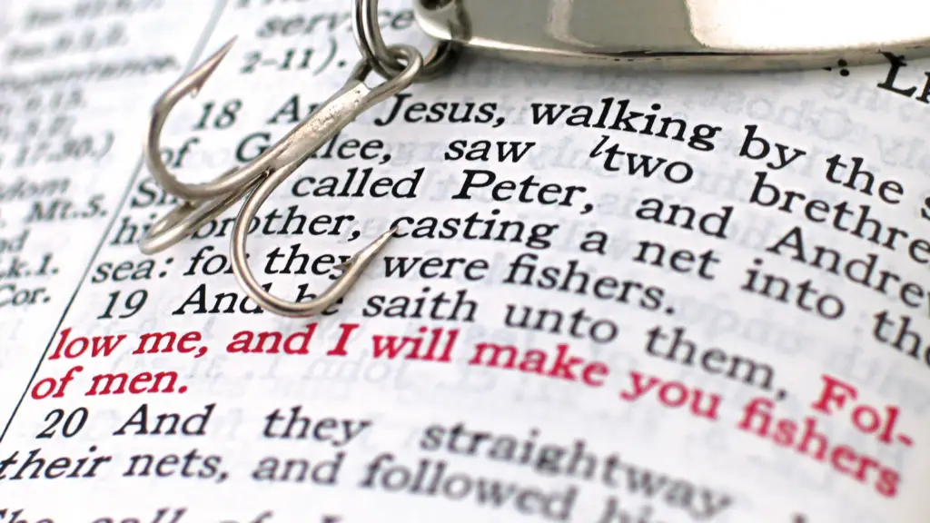 a close view of the Bible with Jesus' words in read talking of being fishers of men with a fishing hook sitting above the words.