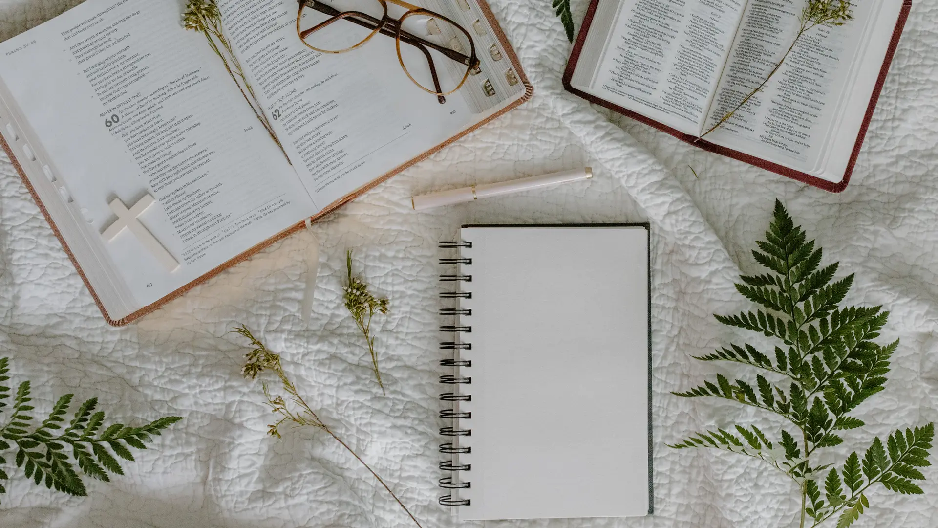 notepad and bible open on a bed with a heartfelt letter to christian educators started