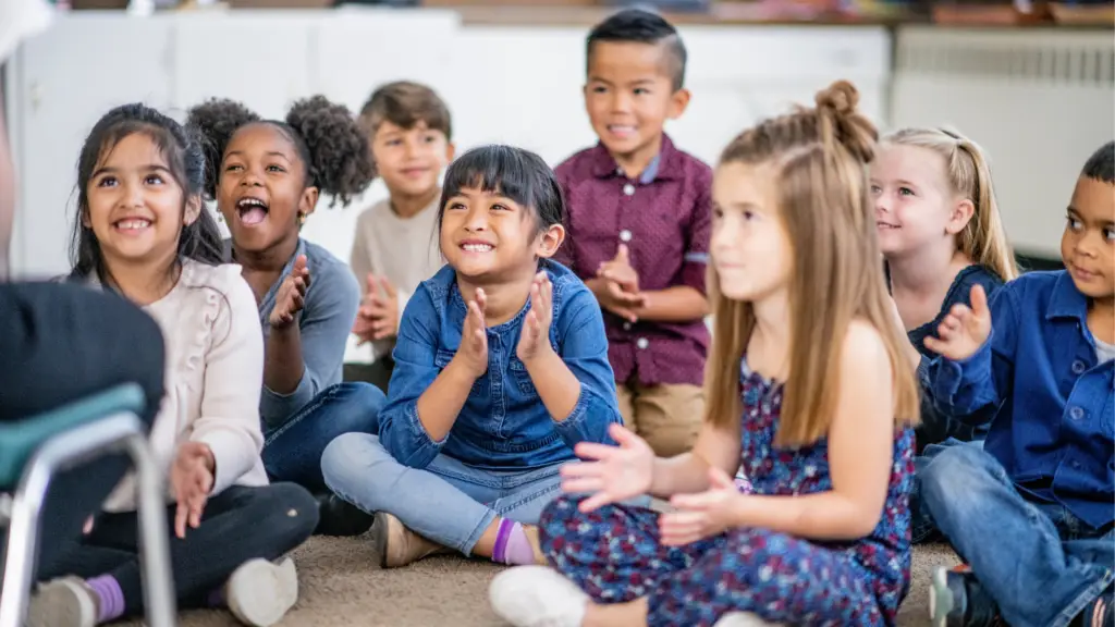 students smiling sitting in a class showing a positive classroom community culture